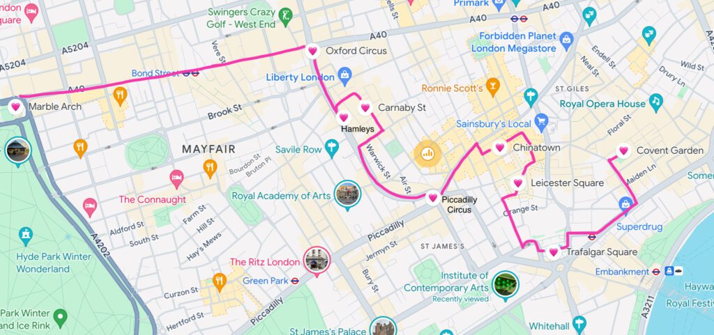 A Google Maps screenshot of London, England around the city area. There's a pink line running from Marble Arch down to Oxford Circus, Hamleys, Carnaby Street, Piccadilly Circus, Chinatown, Leicester Square, Trafalgar Square and Covent Garden "How to Have the Best Time in London (For Free!)"