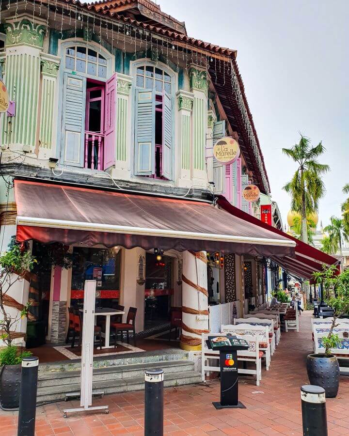 A beautiful building with coloured windows on the top level and big awnings on the bottom in Singapore "Singapore: A Complete Guide to the Public Transport System"