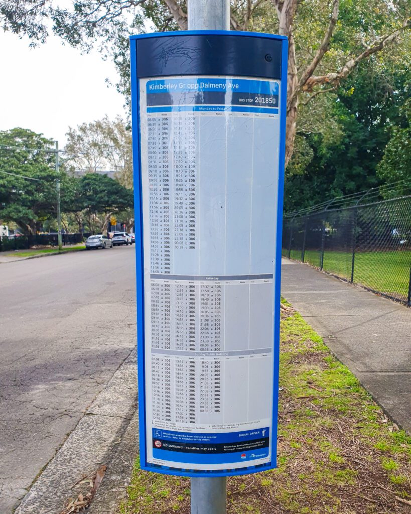 A sign with a bunch of times listed for the bus in Sydney "A Complete Guide to the Public Transport in Sydney"