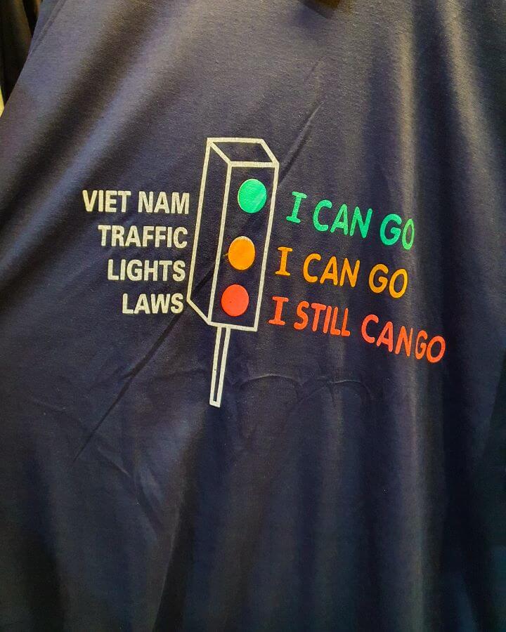 Explore Hanoi: The Most Wonderful Budget Destination. A picture of a tv shirt that says "Vietnam Traffic Light Laws. Green "I can go"  Yellow "I can go" Red "I can still go" that we found in Vietnam