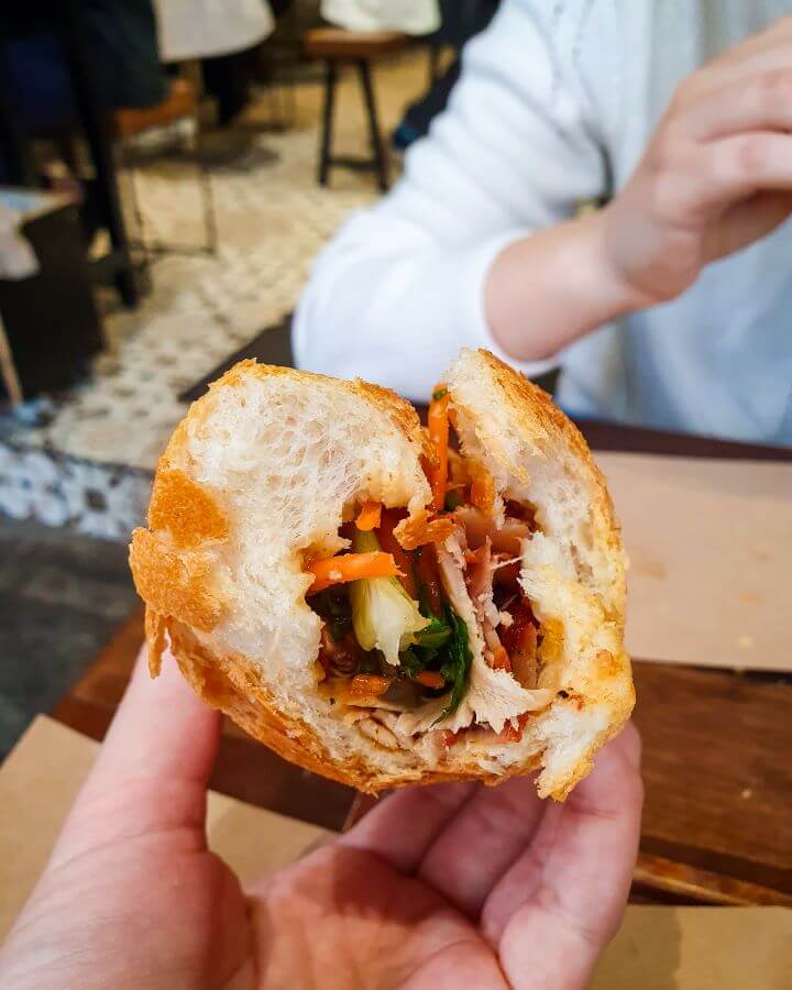 A half eaten Bahn Mi in Hanoi, Vietnam. Inside the roll is some grated carrot, sliced pork and other vegetables and it was delicious "Explore Hanoi: The Most Wonderful Budget Destination"